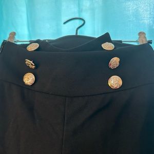 Black dress pants with ornate gold buttons